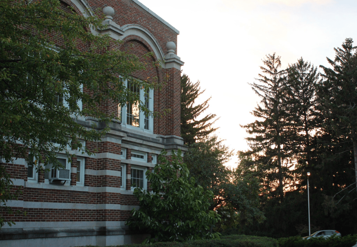 External view of IM Circle with the sun setting behind the trees in the background