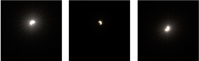 A sequence of three images showing different phases of a solar eclipse at night, with the moon partially covering the sun. Each image captures the sun's bright rays radiating against the dark sky, with the visible crescent of light shifting slightly across the series
