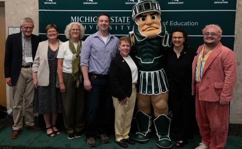 Group of MSU College of Education faculty pose with Sparty