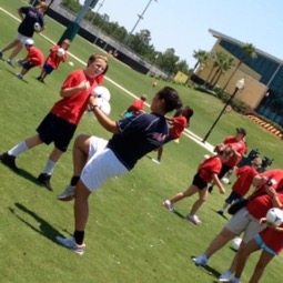Moreno-Raysin plays soccer with youth.