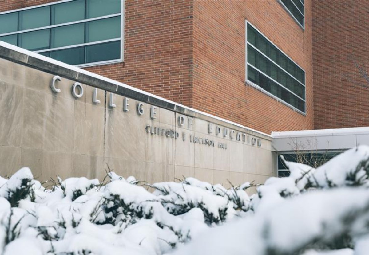 College of Education sign on the side of Erickson Hall building with snowy bushes in the foreground