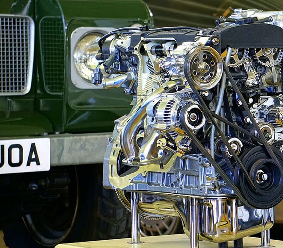 Close up shot of an engine in front of a car