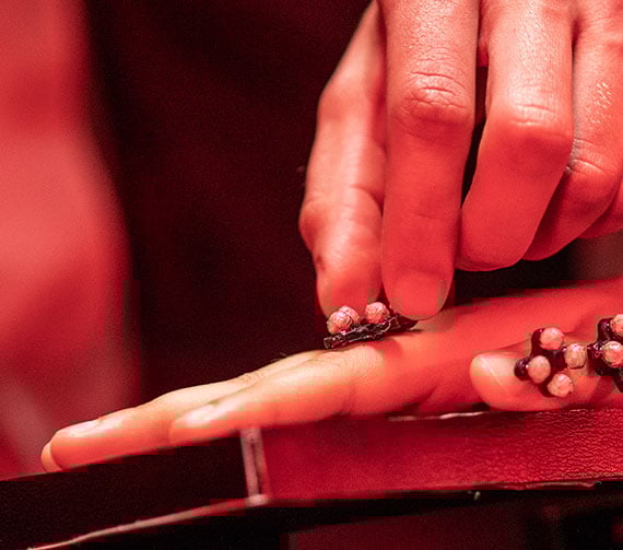 Close up of hands, one hand putting sensor points on the other hand