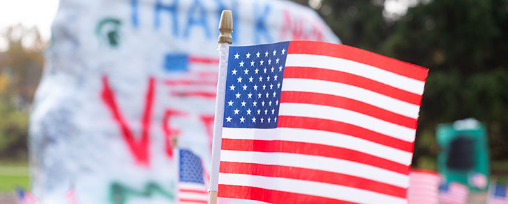 Close up of an American Flag that is in front of the Rock