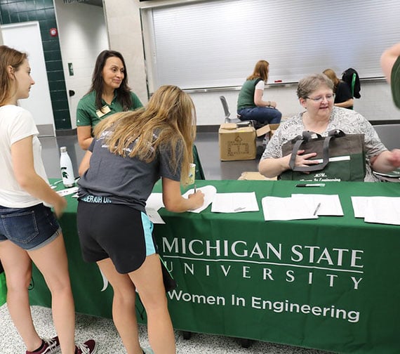 two new first year MSU students signing up to join the Women in Engineering during Colloquium. 