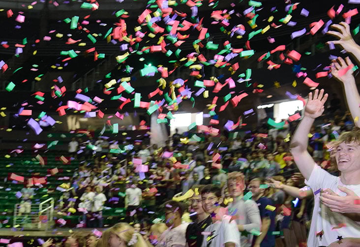 At the Breslin Stadium, first-year students attend the Engineering Colloquium. Confetti fills the air as the students smile and reach for it, celebrating the beginning of their engineering journey at Michigan State University.