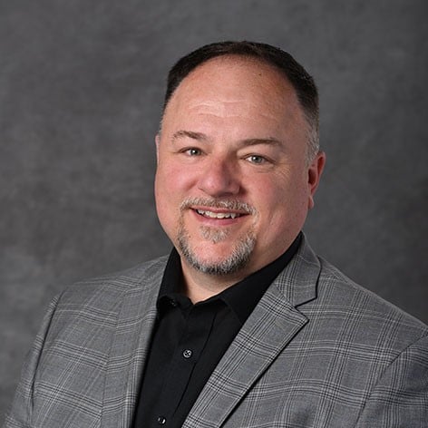 Professional headshot of Andrew Mason