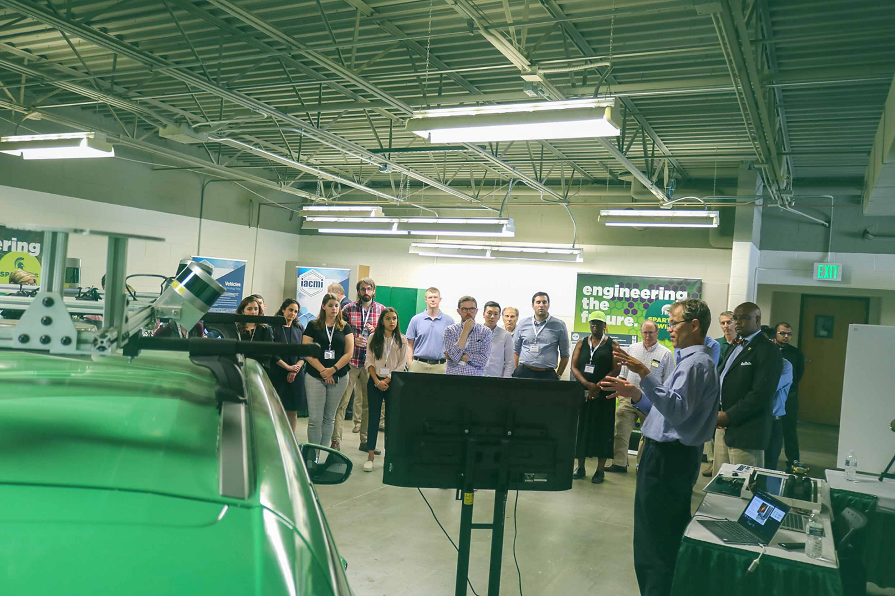 MSU Associate Professor Daniel Morris presents at a 2019 event in the Connected and Autonomous Networked Vehicles for Active Safety, or CANVAS, lab space. Credit: Courtesy of MSU College of Engineering