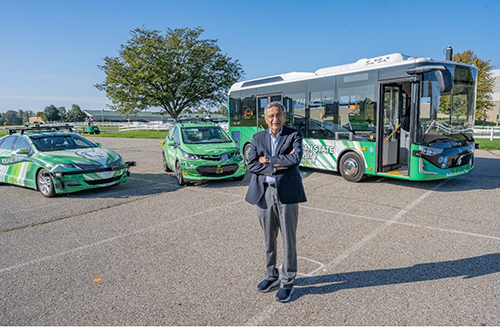 Interim Director of Mobility Satish Udpa and three of MSU's autonomous vehicles.