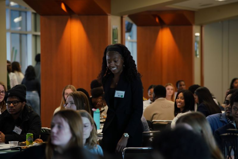 Kapricia Guice standing up and walking to accept award at the Dean's Showcase of Stars