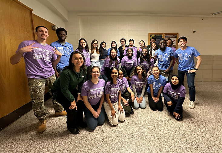 Diverse range of students standing together for a photo with Recruitment and K-12 Outreach, Director, Teresa Isela Vandersloot