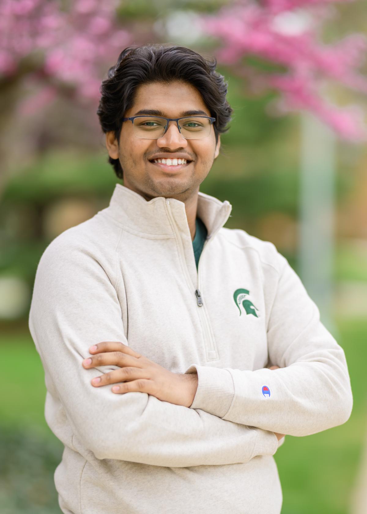 Photo of Om Y. Nair standing in a white Spartan shirt.
