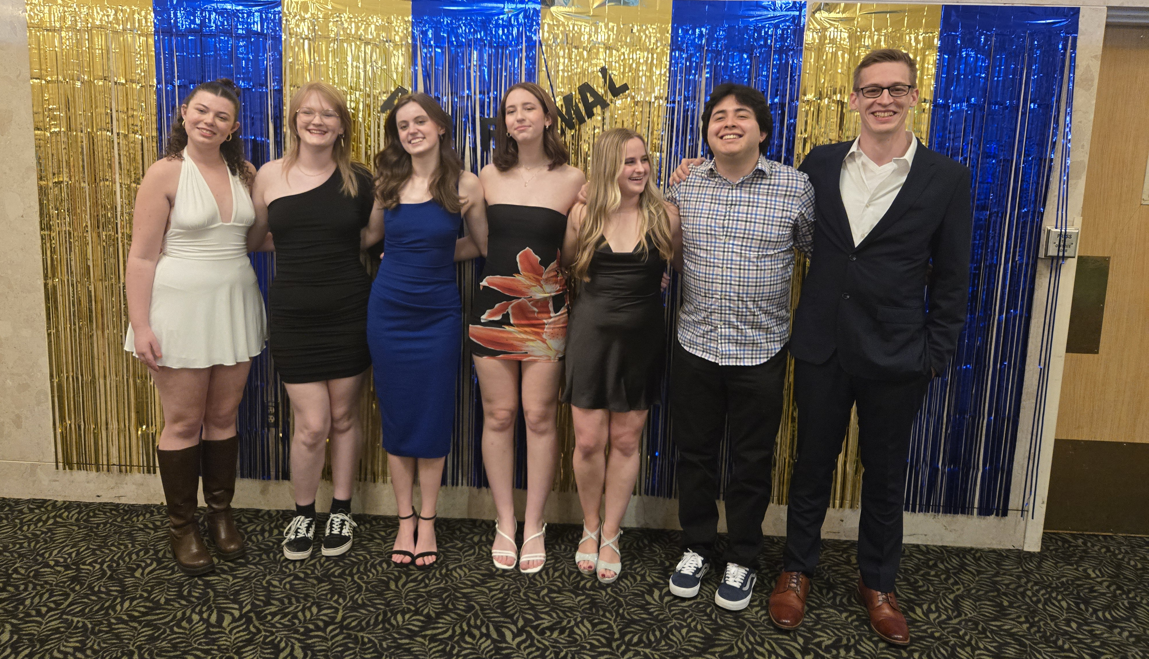 students in formal wear smiling