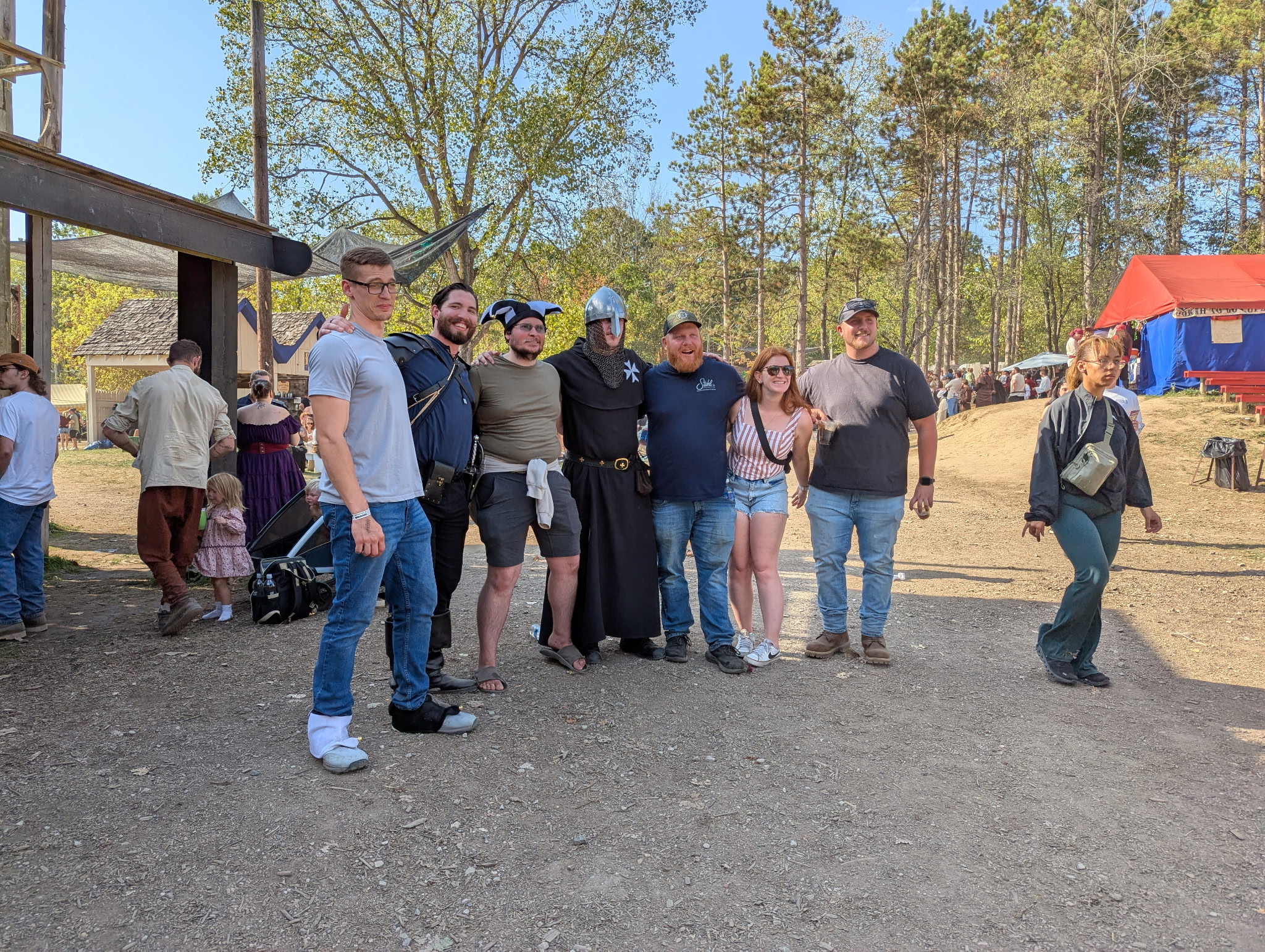 A group poses for a photo with renaissance actors