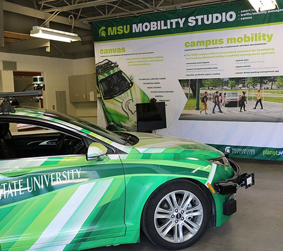 CANVAS vehicle at an event, the CANVAS sign is behind the car