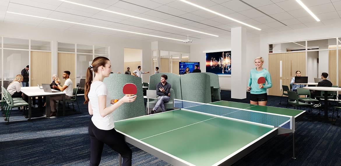 Open space with ping pong tables and seating areas; people playing and working on laptops.