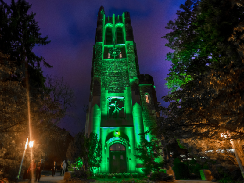 Beaumont Tower at night lit up in green lights