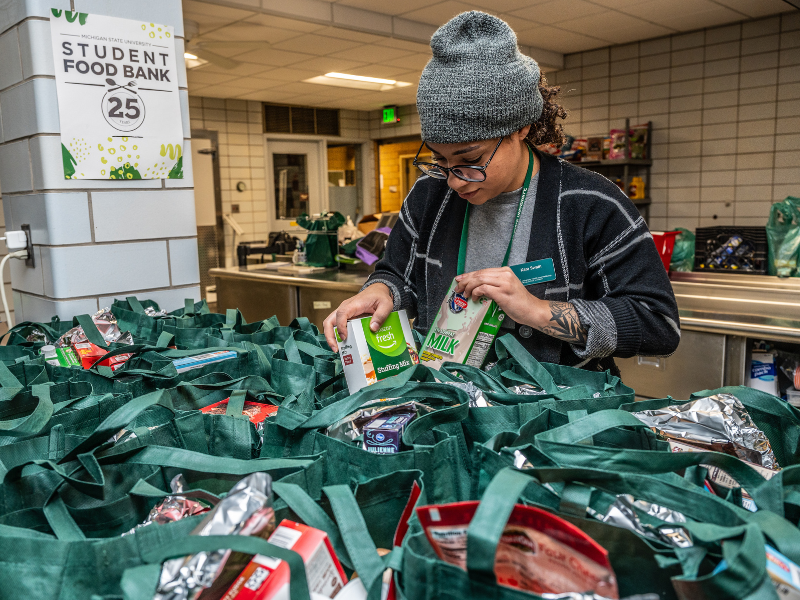 Volunteer packing bags of food at MSU student food bank
