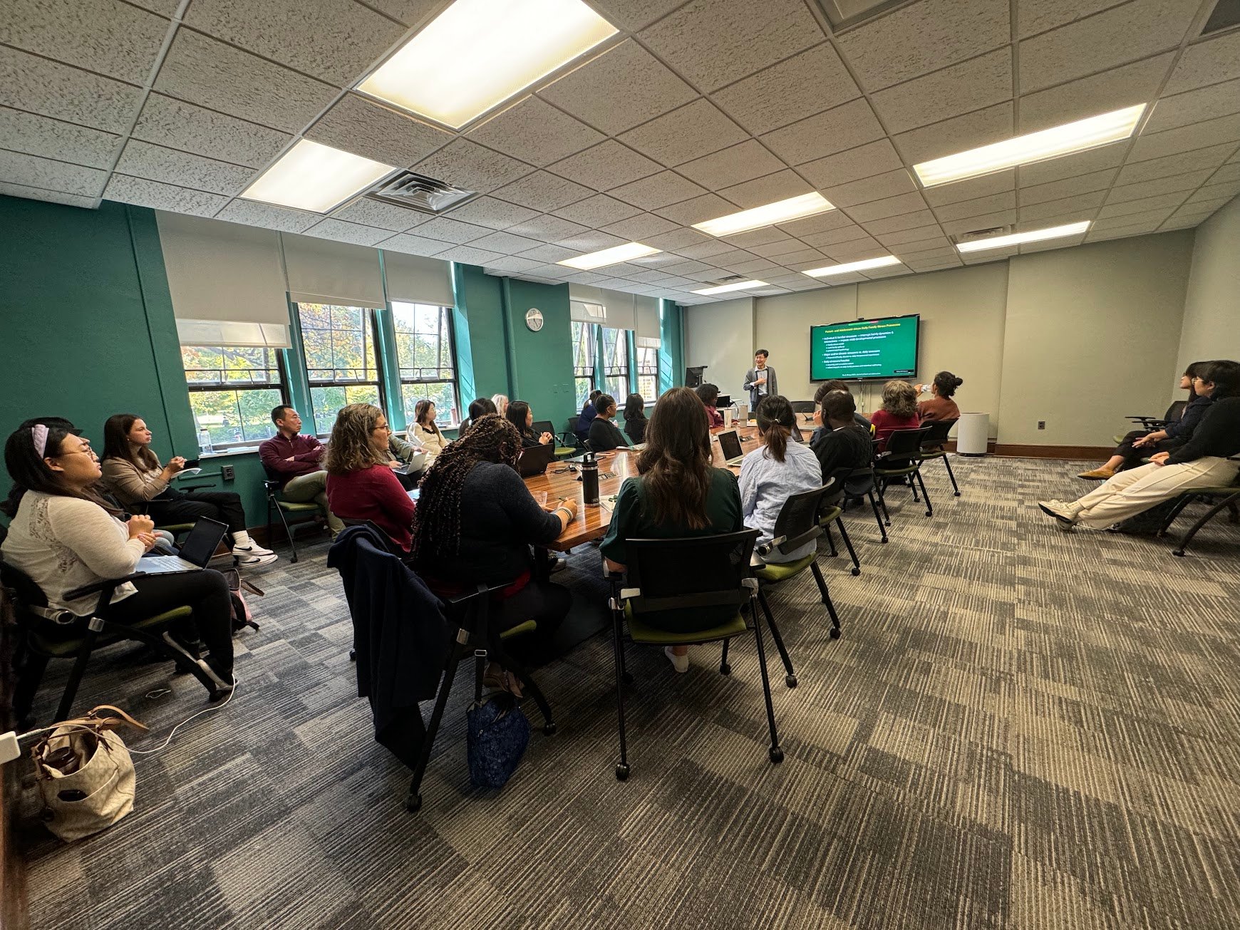 People in a conference room listening to a presenter.