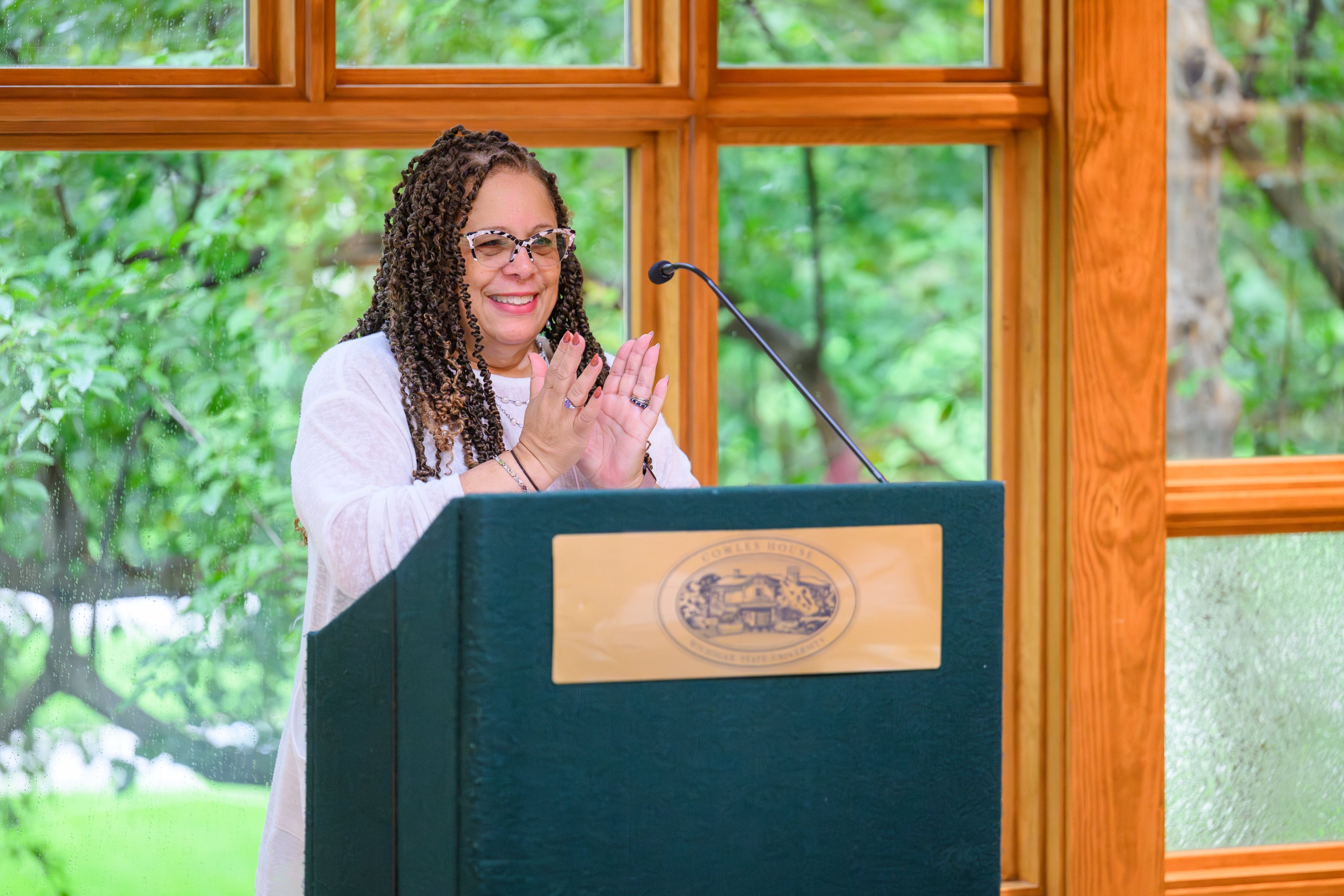 Deborah Johnson speaking at a podium.