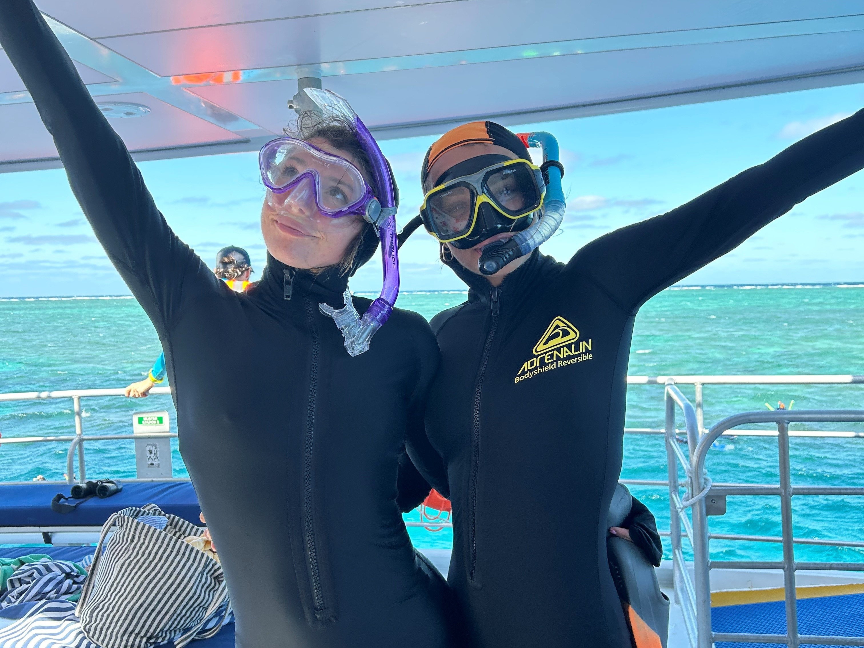 Two women in snorkle suits and goggles.
