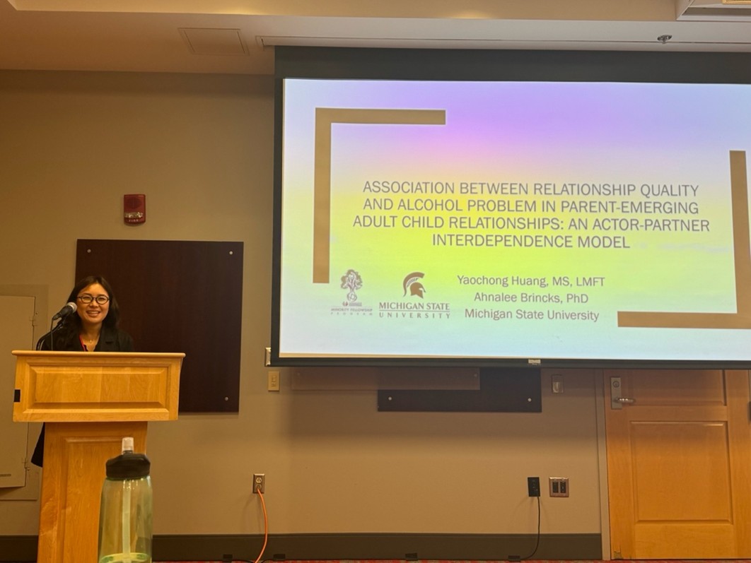 Lucinda Huang gives a presentation at a podium.