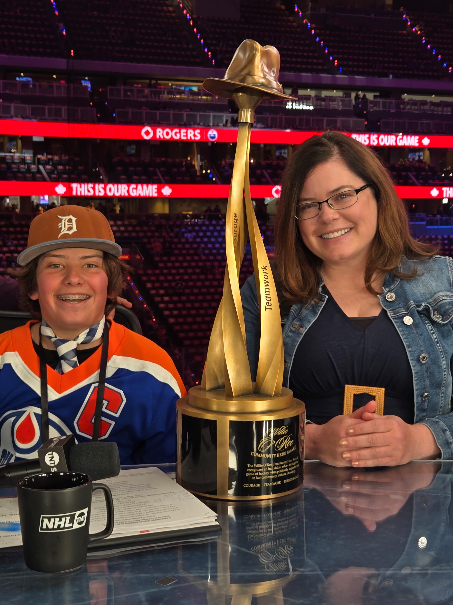 Sarah and her son Cale smile with the award trophy.