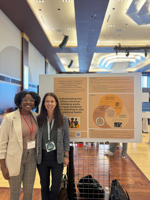Two women next to a poster.