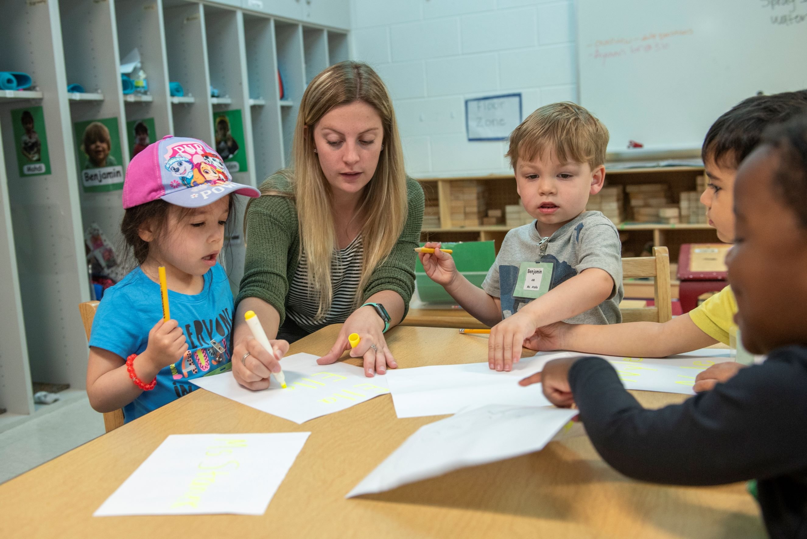 Teacher with children coloring.