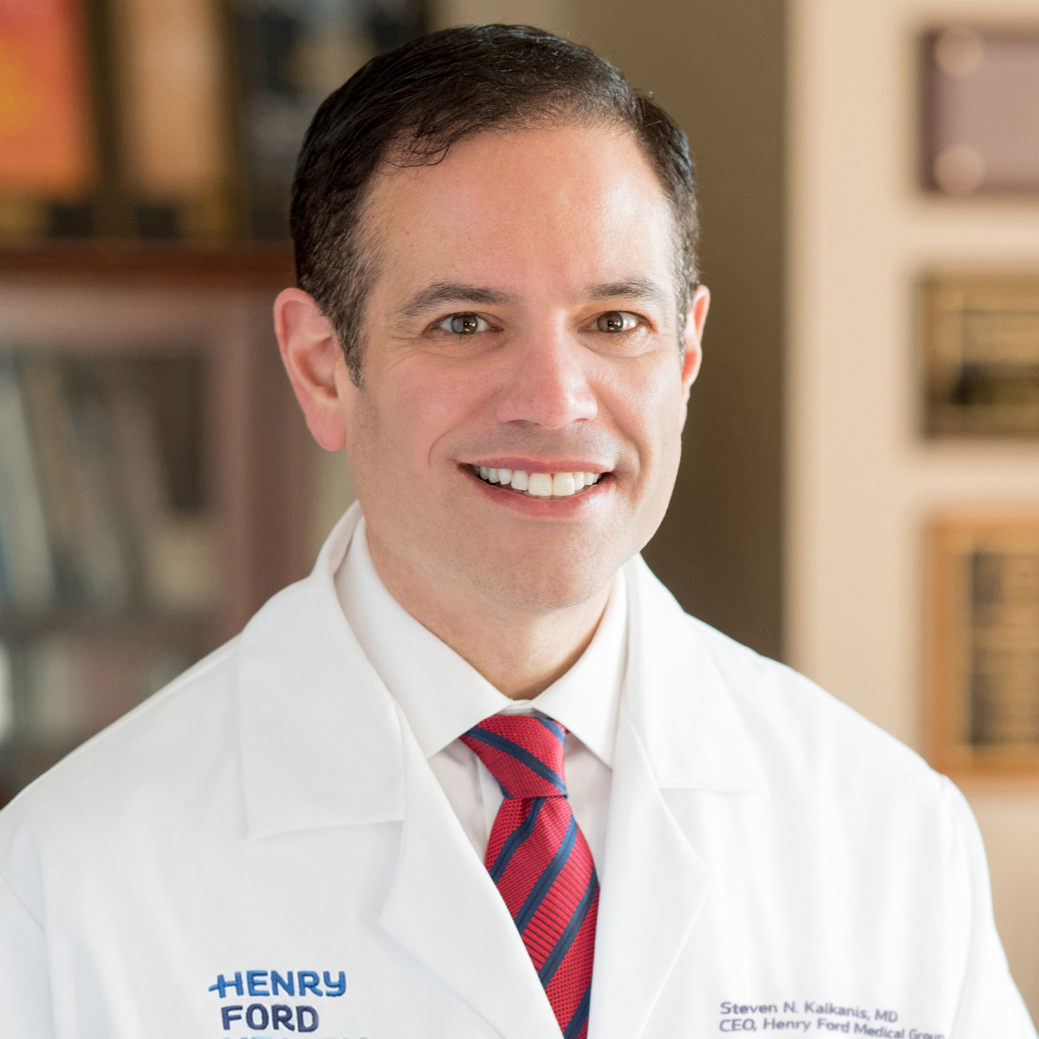 Potrait of Steve Kalknis smiling while wearing a white coat.