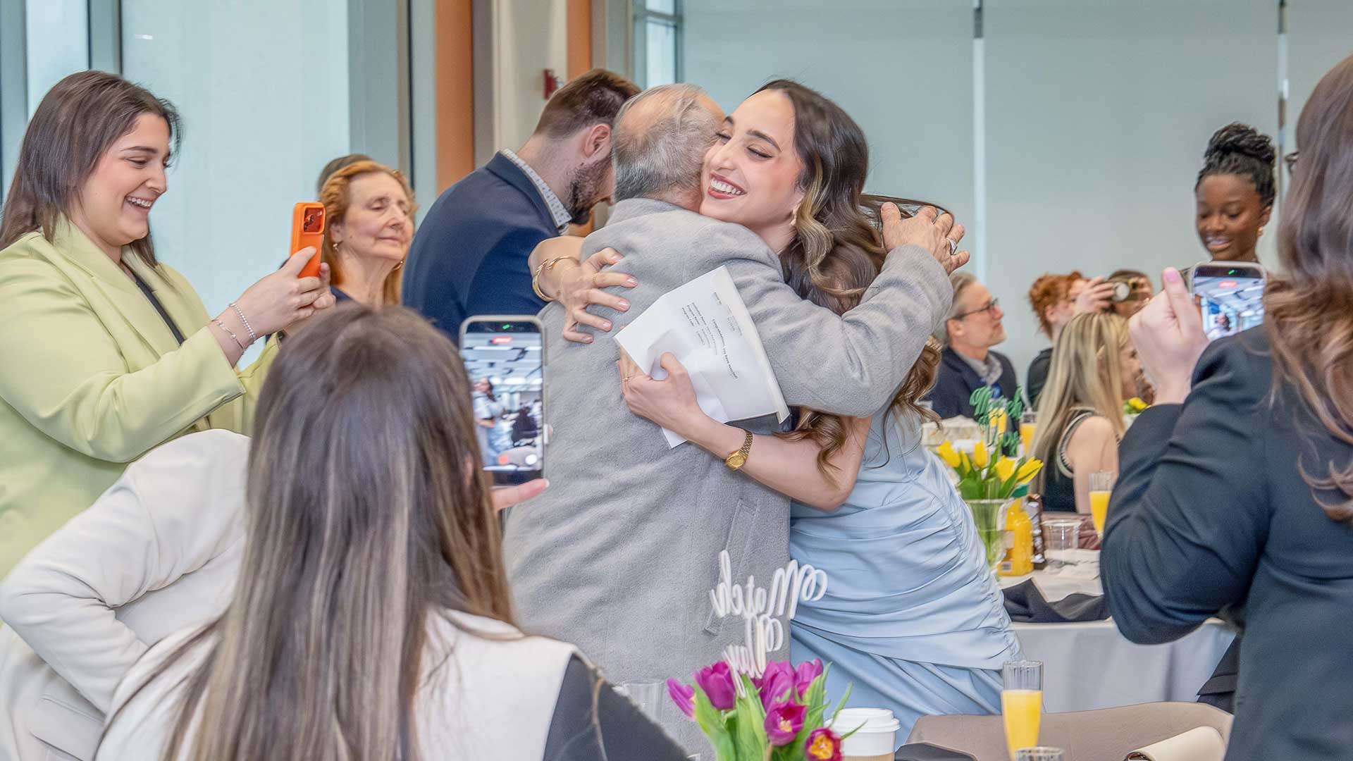 female student hugging family members