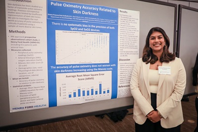 Gnana Prasuna Dutt Gullanki of Henry Ford Health showcases her first research poster during the symposium.