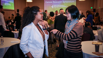 two female researchers discussing during a break