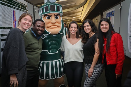 Cancer Researchers posing with MSU mascot Sparty