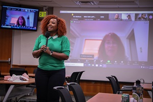 host giving opening remarks before the screening