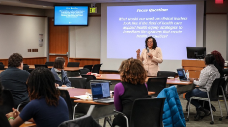host speaking in front of event attendees