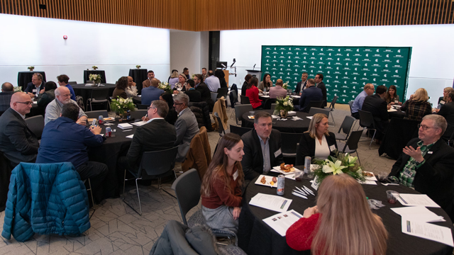 Event attendees sitting at tables discussing