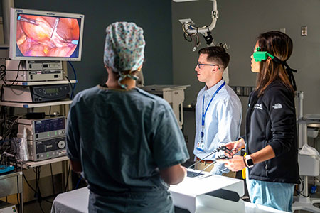 MSU student with a Henry Ford surgeon working with equipment
