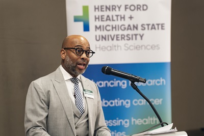 MSU College of Education Dean speaking at a podium.