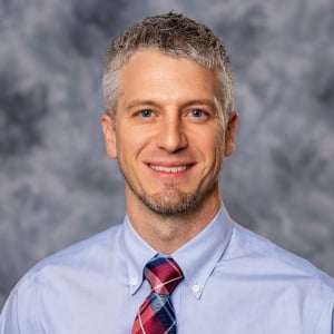 A headshot photo of doctor Travis Gordon