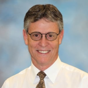 A headshot photo of Mark Hodgins