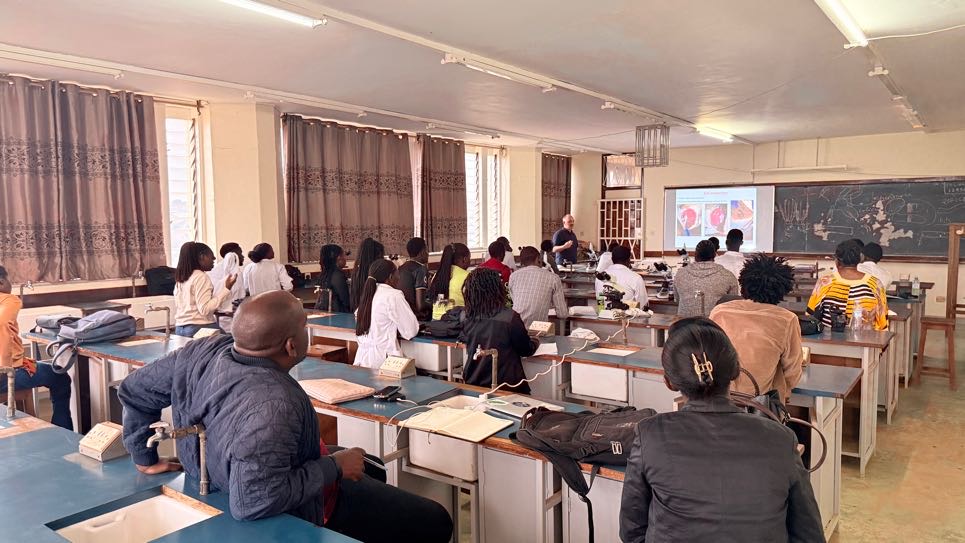 Dr. Bartolomeo Gorgoglione giving a presentation to students in a large classroom