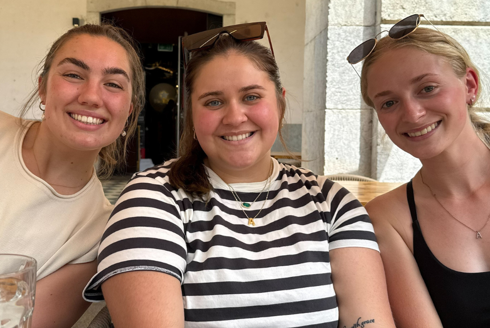 Ava Richardson sitting at a dinner table with two friends during a Spain Education Abroad trip