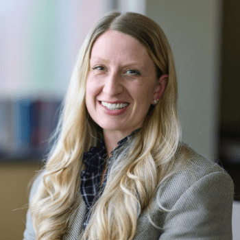 Brianne Wolf wearing a blazer and blue checked shirt.