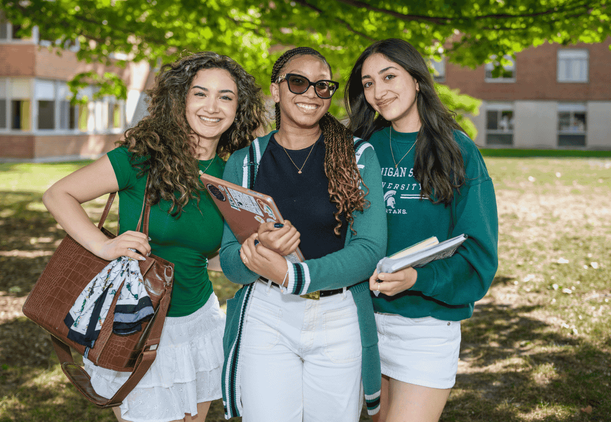 Three JMC students standing together outside of Case Hall.