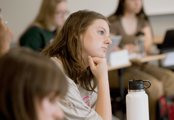 Photo of Madison student with hand on her chin during a class.