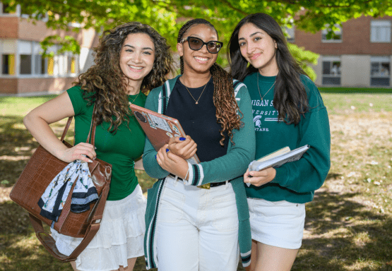 Three JMC students standing together outside of Case Hall.