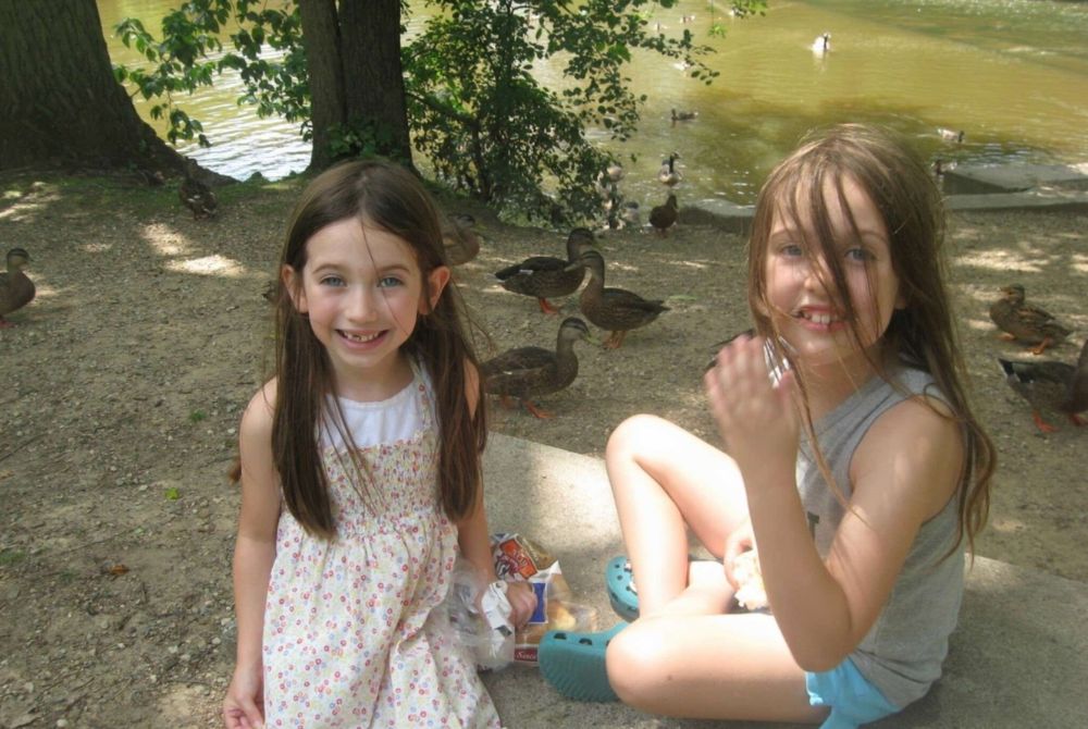 Finni Padgitt and her sibling feeding ducks along the Red Cedar River as children.