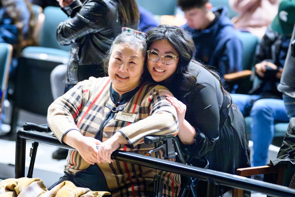 Photo shows JMC student Hanaa Yoo, standing next to her mother. Both are smiling at the camera.