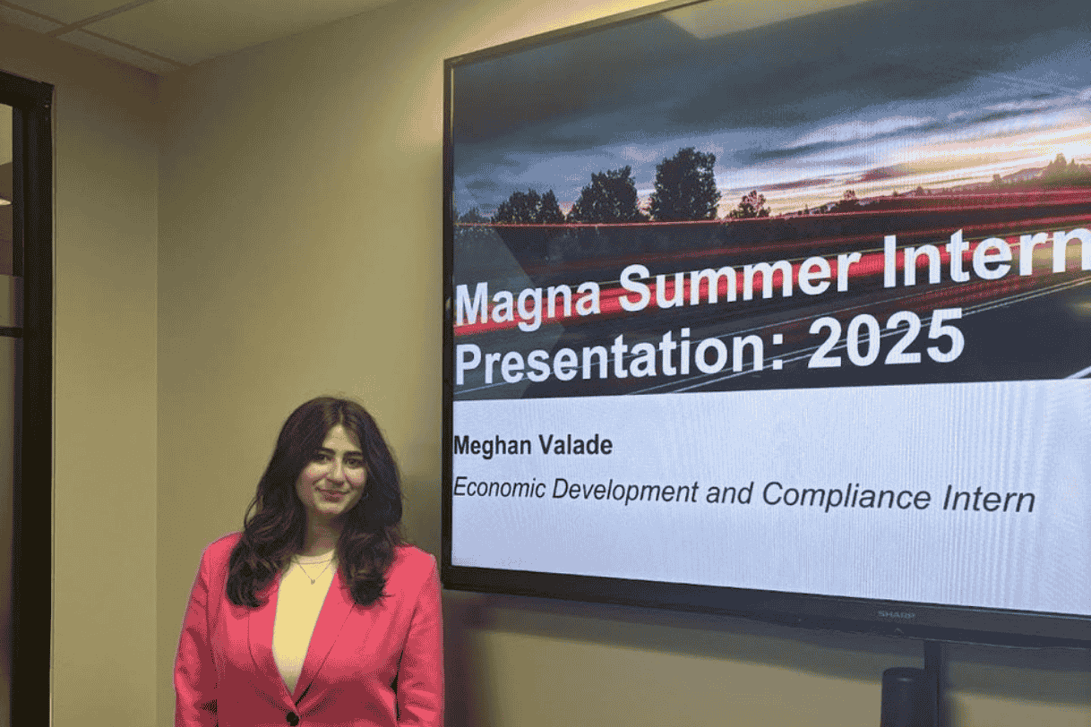 Meghan Valade standing in front of a powerpoint that reads "Magna Summer Internship Presentation: 2025"